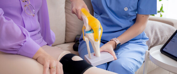 Caregiver or nurse helping check tendon and arthritis of knee or leg for diagnostic and...