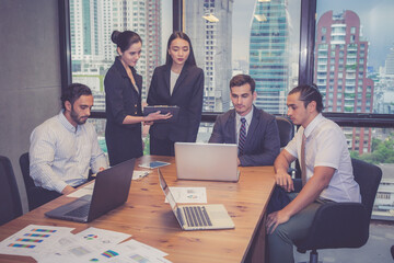 Group of young business team with woman manager standing leader present profit meeting in...