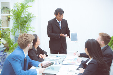 Corporate business team presentation with businessman using tablet in meeting room at modern...