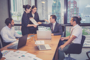 Group of young business team with woman manager standing leader present profit meeting in...