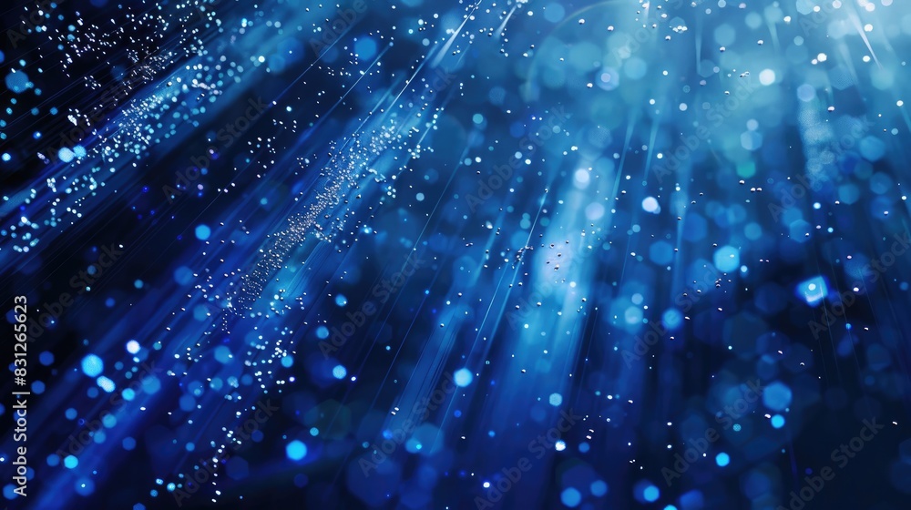Poster blue glitter particles illuminated by delicate light rays, falling in a graceful and enchanting loop