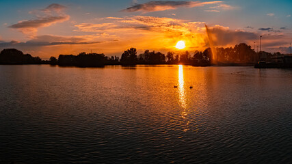Fototapeta premium Sunset with reflections near Plattling, Isar, Bavaria, Germany