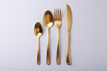 Stylish cutlery set on grey table, flat lay