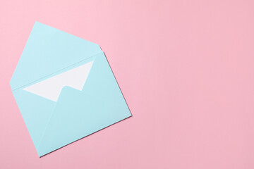Letter envelope with card on pink background, top view. Space for text