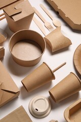Eco friendly food packaging. Paper containers and tableware on white background