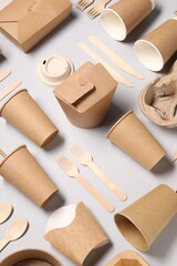 Eco friendly food packaging. Paper containers and tableware on light grey background, above view