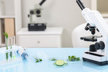 Food quality control. Microscope, petri dishes with different products and other laboratory equipment on light blue table