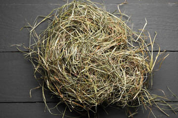 Dried hay on grey wooden table, top view