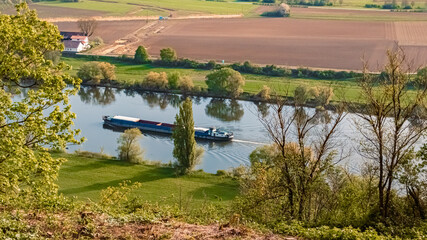 Beautiful spring view with reflections and a cargo ship at Mount Bogenberg, Bogen, Danube, Bavaria,...