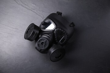 One gas mask on grey textured background, top view