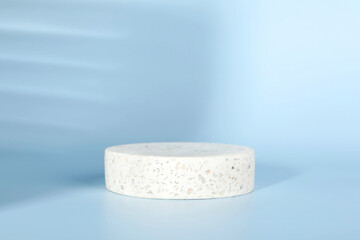 Presentation of product. Round podium and shadows on light blue background. Space for text
