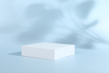 Presentation of product. White podium on light blue background. Space for text