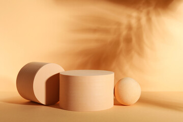 Presentation of product. Podiums and shadows on orange background. Space for text