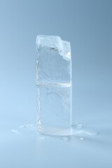 Blocks of clear ice on light blue background