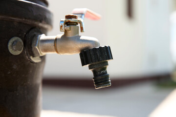 Metal water tap outdoors, closeup. Space for text