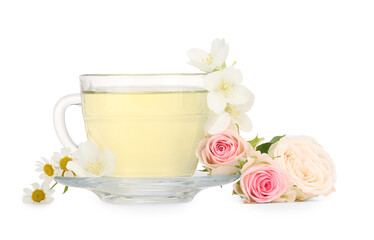 Aromatic herbal tea in glass cup and flowers isolated on white
