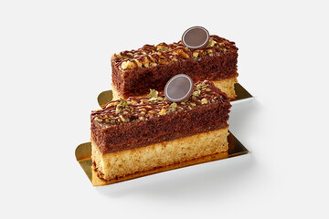 Slices of vanilla and chocolate sponge cake with apple jam and nuts