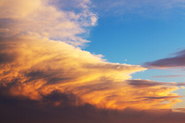 Aerial shot with top view of white fluffy clouds gathering. Beautiful sky at sunset. Bright orange...