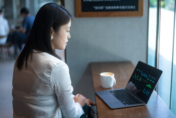 business person working on laptop in cafe