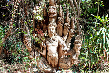 Mystical Wooden Sculpture Harmoniously Placed in a Lush Forest Setting