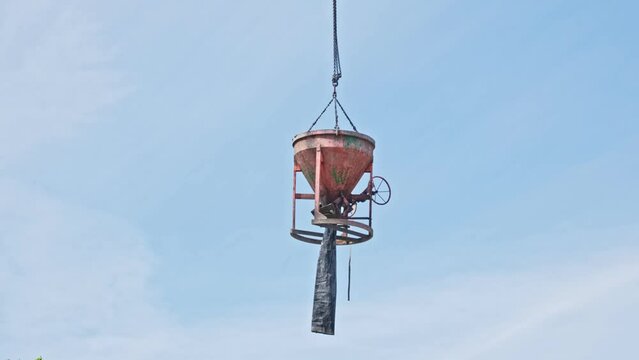 Concrete Funnel Skip for Aiming and Placing Concrete Lifted with Crane over Construction Site