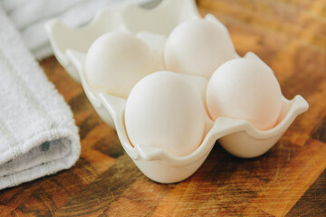 White chicken eggs in ceramic tray