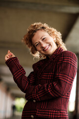 Naklejka premium Low point of view of happy young woman laughing in corridor.