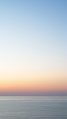 A breathtaking blue and pink sunset over the sea creates