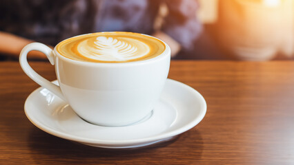 Hot coffee latte in cup mug on the table in cafe coffee shop