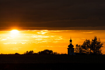 Beautiful sunset and catholic church in the background
