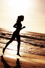 Woman, silhouette and sunset with ocean for runner with fitness or outdoor training with...