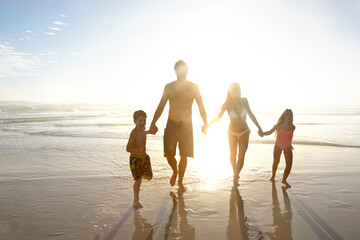 Love, holiday hands and sunset with family on beach, running together on sky for bonding or fun....