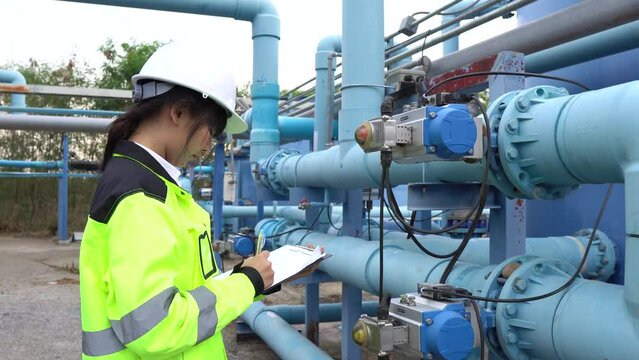 A female engineer working at a water treatment plant, inspecting and maintaining the water supply system, checking chlorine levels, ensuring water quality, and overseeing the dynamo motors and control