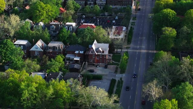 Aerial view of a lively neighborhood in an Americanc ity with houses and treelined streets, sshowcasing urban living and residential buildings