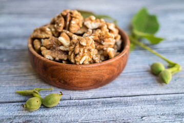Raw Walnuts in a wooden bowl	