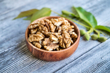Raw Walnuts in a wooden bowl	