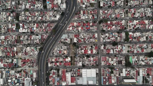 Aerial top-down tracking shot of vehicles driving in Ecatepec, north of CDMX