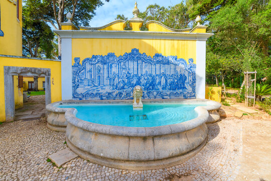A small water feature with stone lion and blue tile at the Museu Condes de Castro Guimaraes, an historic palace with museum and park in Cascais Portugal, along the shores of the Portuguese Riviera.