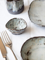 Serving. Author's ceramic tableware. Light background, top view.