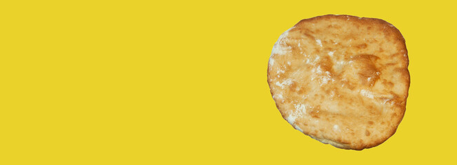 round georgian pita bread on a yellow background. round flat bread on a light surface	