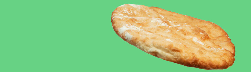 round georgian pita bread on a green background. round flat bread on a light surface	