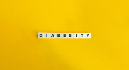 Diabesity Word. The Coexistence of both Diabetes and Obesity. Text on Block Letter Tiles on Yellow...