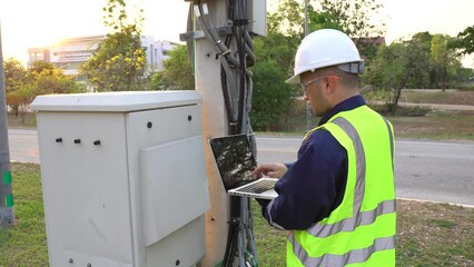 Telecommunications engineer working on a 5G signal tower,inspecting and troubleshooting issues,developing and enhancing the system to ensure optimal 5G network performance and reliable connectivity.