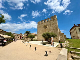 Gothic church Església de Sant Martí d'Empúries and forestry office in the style of Catalan...