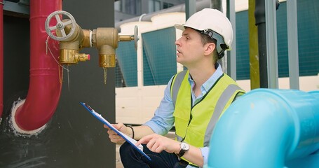A engineer under checking inspects the industry factory pressure water pump valves equipment in a...