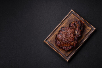 Delicious juicy beef ribeye steak grilled with salt, spices and herbs