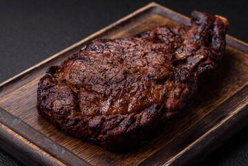 Delicious juicy beef ribeye steak grilled with salt, spices and herbs