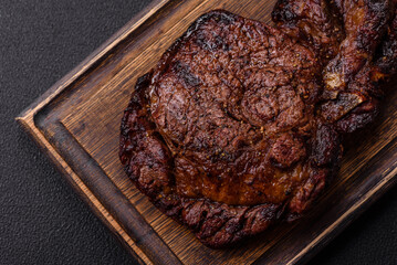 Delicious juicy beef ribeye steak grilled with salt, spices and herbs