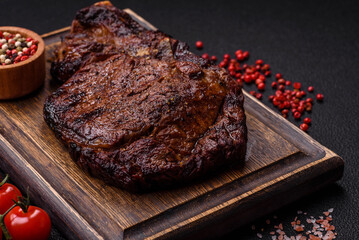 Delicious juicy beef ribeye steak grilled with salt, spices and herbs
