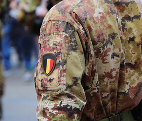 Belgian army soldier in camouflage uniform with the flag of Belgium badge on the sleeve